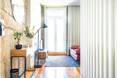 a living room with a couch and a window at Light-filled Bonjardim Apartments in Porto