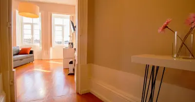 a living room with a couch and a table at Casa do Recanto in Porto