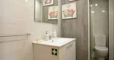 a white bathroom with a sink and a toilet at Casa do Recanto - Loft vista rio in Porto