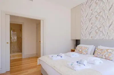 a bedroom with a white bed with towels on it at BOUTIQUE Rentals- THE RIBEIRA***** Apt great views in Porto