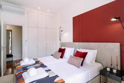 a bedroom with a large bed with red and white pillows at Bruno's Wine House in Vila Nova de Gaia