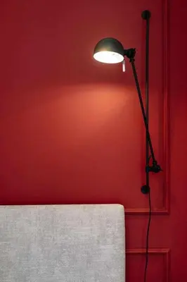 a lamp in a room with a red wall at Bruno's Wine House in Vila Nova de Gaia