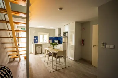 a kitchen and dining room with a table and chairs at Oporto Explorers in Porto