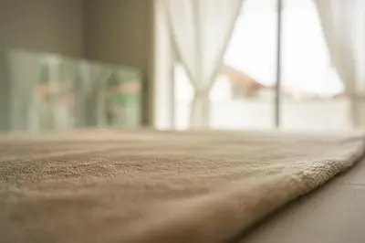 a close up of the edge of a bed with a window at Oporto Explorers in Porto