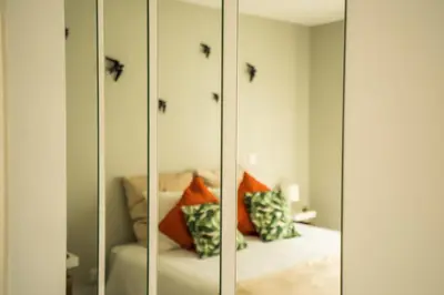 a room with a bed and a mirrored cabinet at Oporto Explorers in Porto