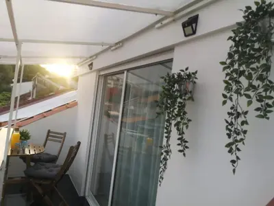 a balcony with a glass door and some plants at Oporto Explorers in Porto