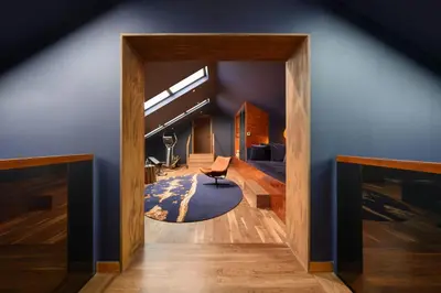 a living room with a chair and a blue wall at Forte de Gaia, Autograph Collection in Vila Nova de Gaia