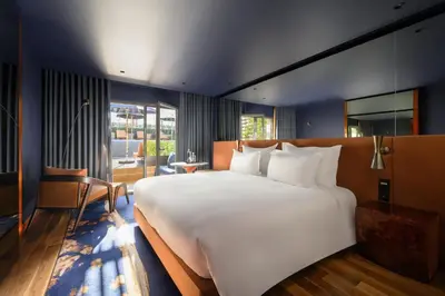 a bedroom with a large bed and a large window at Forte de Gaia, Autograph Collection in Vila Nova de Gaia