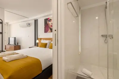 a bedroom with a bed and a glass shower at Terrace Bliss with AC Downtown Porto in Porto