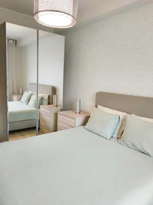 a bedroom with a large white bed and a mirror at Porto Santa Catarina - Apartment with Terrace in Porto