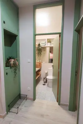 a bathroom with a toilet and a bathroom with green walls at Porto Santa Catarina - Apartment with Terrace in Porto