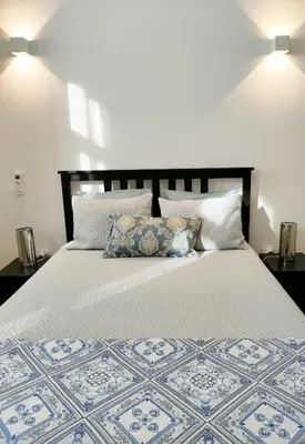 a bedroom with a large white bed with pillows at Porto Historic - Apartment with Private Patio in Porto