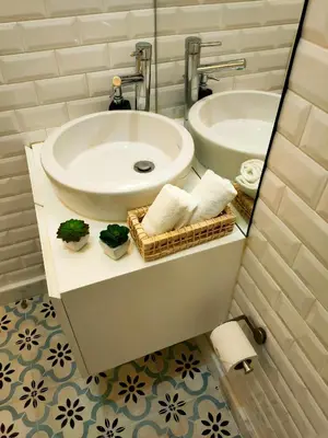a bathroom with a sink and a toilet and a mirror at Porto Historic - Apartment with Private Patio in Porto