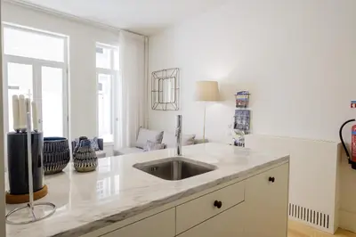 a white kitchen with a sink and a window at BOUTIQUE Rentals-Flores Terrace historical centre in Porto