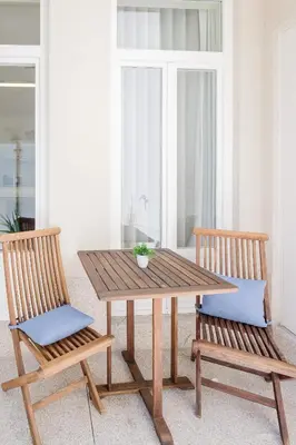 a wooden table and two chairs sitting next to a table at BOUTIQUE Rentals-Flores Terrace historical centre in Porto