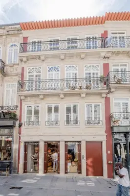 a large white building with windows and a balcony at BOUTIQUE Rentals-Flores Terrace historical centre in Porto