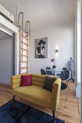 a living room with a yellow couch and a table at Fashion Luxury House in Porto