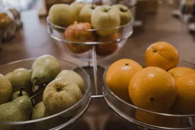 a bunch of fruit in bowls on a table at Vilar Oporto Hotel in Porto