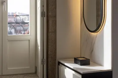 a mirror on a wall next to a door at ORM Batalha Apartments in Porto