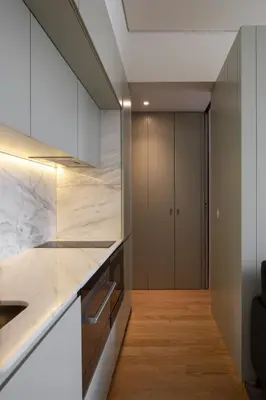 a kitchen with marble countertops and a hallway at ORM Batalha Apartments in Porto
