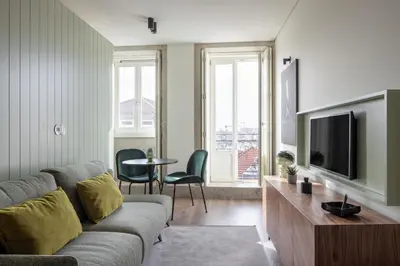 a living room with a couch and a tv at ORM Batalha Apartments in Porto