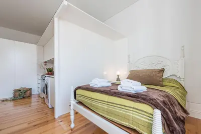 a bedroom with a bed with towels on it at GuestReady - Coral Apartment in Porto