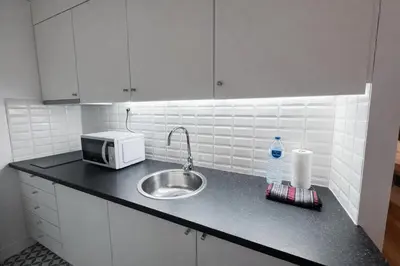 a kitchen counter with a sink and a microwave at Oporto City View - Trindade in Porto