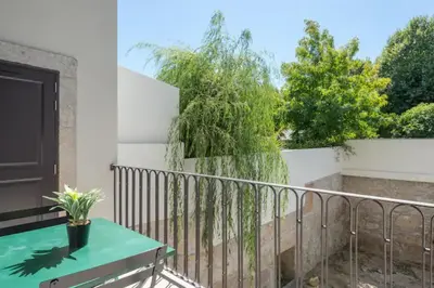 a balcony with a table and a tree at Sweety Balcony Porto Center in Porto