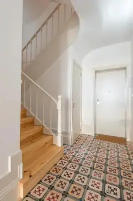 a hallway with a staircase with a tile floor at Sweety Balcony Porto Center in Porto