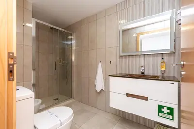 a bathroom with a toilet and a sink and a mirror at Feel Porto Corporate Housing Marquês in Porto