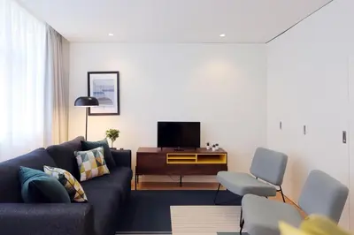 a living room with a couch and a tv at HM - Sta. Catarina Charming Apartment in Porto