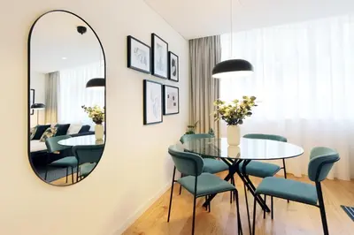 a dining room with a table and chairs and a mirror at HM - Sta. Catarina Charming Apartment in Porto