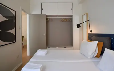 a bedroom with a large white bed with white pillows at Spot Apartments in Porto