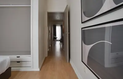 a bedroom with a bed and a tv on a wall at Spot Apartments in Porto