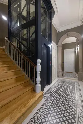a hallway with a blue door and wooden stairs at Cinema Luxury House in Porto
