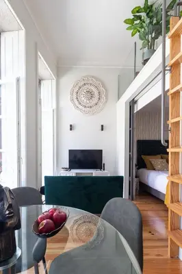 a living room with a glass table and a bed at Cinema Luxury House in Porto