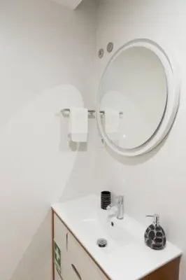 a bathroom with a sink and a mirror at Warmly Porto in Porto