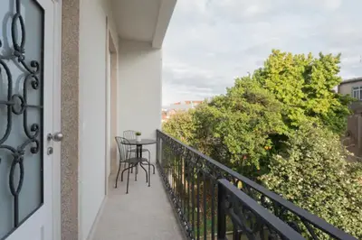 a balcony with a table and chairs on it at Warmly Porto in Porto