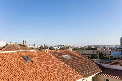 a view of roofs of buildings in a city at Vila Burgães by LovelyStay in Porto