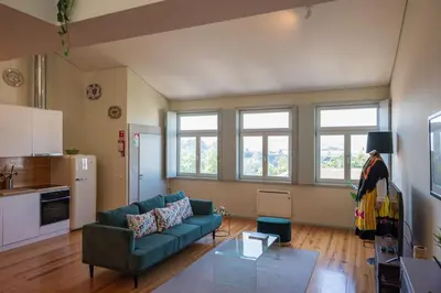 a living room with a couch and some windows at History Porto in Porto