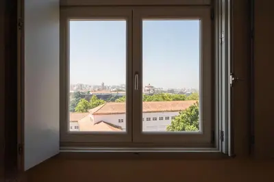 a window with a view of a building at History Porto in Porto
