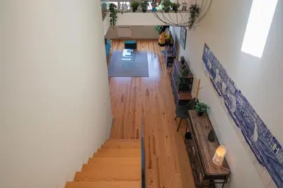 a hallway with wooden floors and stairs in a building at History Porto in Porto