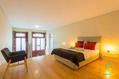 a bedroom with a large bed and a chair at Pretty Porto in Porto