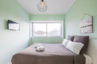 a bedroom with a bed with a stuffed animal on it at GuestReady - Wellspring Bloom in Porto