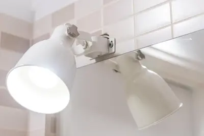 a bathroom with a toilet with a light on it at GuestReady - Wellspring Bloom in Porto