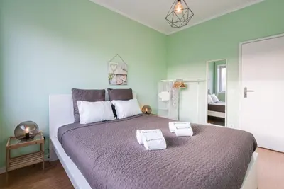 a bedroom with a large bed with towels on it at GuestReady - Wellspring Bloom in Porto