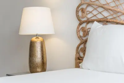 a lamp sitting on a table next to a bed at GuestReady - Mystic Subdual in Porto
