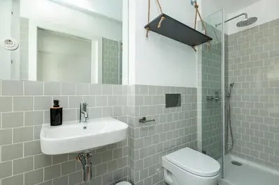 a bathroom with a sink and a toilet and a shower at Virtudes River Views by Porto City Hosts in Porto