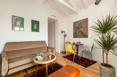 a living room with a couch and a table and chairs at Virtudes River Views by Porto City Hosts in Porto