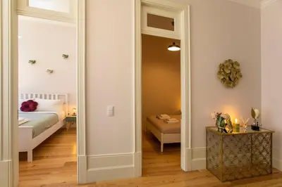a bedroom with a bed and a large mirror at LovelyStay - 2BR Flat with AC in Duque de Loulé in Porto